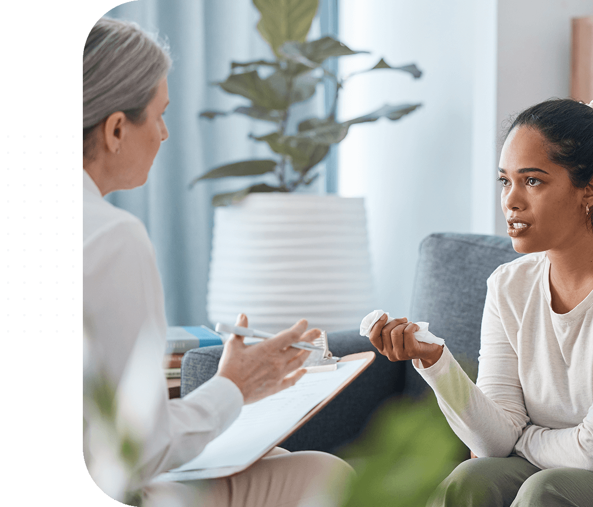 Woman speaking to therapist in office.